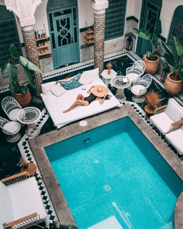 A woman lays out by the side of a pool